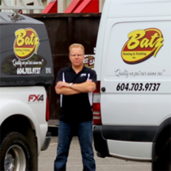 A man standing in front of a white truck owned by Batz Inc.